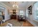 Charming dining area featuring an elegant chandelier, custom seating, and lovely natural light at 1905 Lone Oak Pt, Mount Pleasant, SC 29466