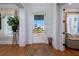 Bright entryway with hardwood floors, white paneled walls, a glass-paneled door, and colorful rug at 1905 Lone Oak Pt, Mount Pleasant, SC 29466