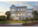 Charming two-story white home boasting a welcoming front porch, manicured landscaping, and abundant curb appeal at 1905 Lone Oak Pt, Mount Pleasant, SC 29466