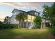 Rear elevation showing multi-story home with large windows and a well-maintained lawn at 1905 Lone Oak Pt, Mount Pleasant, SC 29466