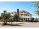 Beautiful two-story building featuring a symmetrical design with brick accents, columned porch, and classic architectural elements at 1905 Lone Oak Pt, Mount Pleasant, SC 29466