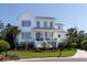 Charming two-story home with landscaped yard, inviting front porch, and a classic white exterior with gray trim at 1905 Lone Oak Pt, Mount Pleasant, SC 29466
