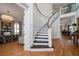 Elegant foyer with a curved staircase, chandelier, hardwood floors, and wainscoting at 1905 Lone Oak Pt, Mount Pleasant, SC 29466