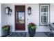 Inviting front porch with mahogany door, stylish lanterns, planters, and a cozy seating area with patterned rug at 1905 Lone Oak Pt, Mount Pleasant, SC 29466