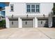 Well-maintained three-car garage with modern doors and elegant sconces, adding functionality and aesthetic appeal to the home at 1905 Lone Oak Pt, Mount Pleasant, SC 29466