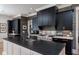 Gourmet kitchen featuring sleek black cabinets, a large island, and professional-grade appliances at 1905 Lone Oak Pt, Mount Pleasant, SC 29466