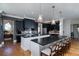 Spacious kitchen with dark cabinetry, a large center island, and modern pendant lighting at 1905 Lone Oak Pt, Mount Pleasant, SC 29466