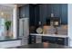 Modern kitchen featuring navy cabinets, stainless steel appliances, and granite countertops at 1905 Lone Oak Pt, Mount Pleasant, SC 29466