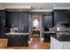 Stylish kitchen featuring black cabinets, stainless steel appliances, and hardwood floors at 1905 Lone Oak Pt, Mount Pleasant, SC 29466