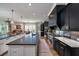Well-appointed kitchen with an island bar, modern lighting, and an open layout to the dining area at 1905 Lone Oak Pt, Mount Pleasant, SC 29466