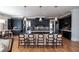 Open-concept kitchen featuring dark cabinets, a large island with seating, and stylish pendant lights at 1905 Lone Oak Pt, Mount Pleasant, SC 29466