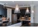 Modern kitchen with stainless steel appliances, dark cabinetry, and elegant pendant lighting at 1905 Lone Oak Pt, Mount Pleasant, SC 29466