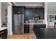 Stylish kitchen featuring a stainless steel refrigerator, dark cabinetry, and hardwood flooring at 1905 Lone Oak Pt, Mount Pleasant, SC 29466