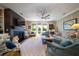 Spacious living room with fireplace, built-ins, ceiling fan, and access to the outdoor deck at 1905 Lone Oak Pt, Mount Pleasant, SC 29466