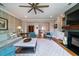 Comfortable living room with fireplace, ceiling fan, and stylish furniture, perfect for relaxing or entertaining guests at 1905 Lone Oak Pt, Mount Pleasant, SC 29466