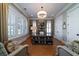 Stylish home office with custom built-ins, plantation shutters, hardwood floors, and designer lighting at 1905 Lone Oak Pt, Mount Pleasant, SC 29466