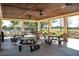 A community pavilion with picnic tables, ceiling fans, and a view of the pool and golf course at 1905 Lone Oak Pt, Mount Pleasant, SC 29466