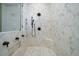 Luxurious walk-in shower featuring marble tiles, built-in shelving, and bronze fixtures at 1905 Lone Oak Pt, Mount Pleasant, SC 29466
