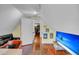 Attic room features hardwood floors, TV, couch, and closet space at 197 Coming St, Charleston, SC 29403