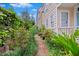 Lush backyard garden featuring brick pathway, green foliage, and blooming rose bushes at 197 Coming St, Charleston, SC 29403