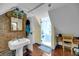 Bathroom with a glass shower, brick wall, and classic fixtures, offering modern comfort at 197 Coming St, Charleston, SC 29403