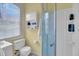 Bathroom featuring a white toilet, shower, and cabinetry with natural light from the window at 197 Coming St, Charleston, SC 29403