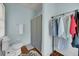 Bathroom with a shower featuring a striped curtain and storage rack with hanging clothes at 197 Coming St, Charleston, SC 29403