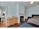 Bedroom featuring a fireplace, wood floors, and a comfortable bed at 197 Coming St, Charleston, SC 29403