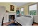 Bedroom featuring a fireplace, wood floors, and comfortable furnishings at 197 Coming St, Charleston, SC 29403