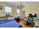 Bedroom with wood flooring, bed, desk, and natural light from the windows at 197 Coming St, Charleston, SC 29403