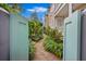Charming courtyard featuring a brick path and lush greenery, offering a private outdoor space at 197 Coming St, Charleston, SC 29403