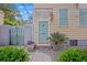 Welcoming entrance with a teal door, black iron gate, and lush landscaping at 197 Coming St, Charleston, SC 29403