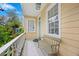 Charming front porch with a teal door, bench, and white railing, offering a cozy outdoor space at 197 Coming St, Charleston, SC 29403