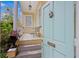 Charming front porch with a teal door, bench, and white railing, offering a cozy outdoor space at 197 Coming St, Charleston, SC 29403