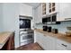 Modern kitchen with stainless steel appliances, white cabinets, and a stylish backsplash at 197 Coming St, Charleston, SC 29403