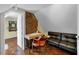 Office with exposed brick wall, desk, sofa, and adjacent bathroom at 197 Coming St, Charleston, SC 29403