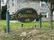 Welcoming sign for 'The Savannah' community, set against a backdrop of lush greenery and well-maintained facade at 2040 Rondo St # H, Charleston, SC 29414