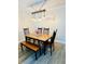 Dining area with a wooden table, chandelier lighting, and modern decor, perfect for Gathering meals at 2040 Rondo St # H, Charleston, SC 29414