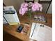 Cozy dining table arrangement with informational real estate papers, business cards, and fresh floral decor at 2040 Rondo St # H, Charleston, SC 29414