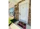 Inviting townhouse entrance with white door, brick facade, and 'Welcome' mat at 2040 Rondo St # H, Charleston, SC 29414