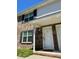 Townhouse entrance featuring a white door, brick facade, and blue shutters, creating curb appeal at 2040 Rondo St # H, Charleston, SC 29414