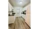Well-lit kitchen featuring white cabinets, dark countertops, and modern appliances at 2040 Rondo St # H, Charleston, SC 29414