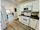 Kitchen with white cabinets, modern appliances, and an open layout to the living area at 2040 Rondo St # H, Charleston, SC 29414