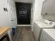 Charming laundry area with modern appliances and decorative 'Welcome Home' chalkboard, blending functionality and style at 2040 Rondo St # H, Charleston, SC 29414