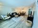 Bright living room with hardwood floors, modern furniture, and open layout to the dining area at 2040 Rondo St # H, Charleston, SC 29414