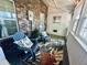 Cozy enclosed porch with comfortable seating, stylish rug, and brick accents at 2040 Rondo St # H, Charleston, SC 29414