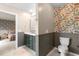 Cozy bathroom featuring an olive vanity, patterned wallpaper, and marble floors at 206 Red Bluff St, Summerville, SC 29483