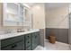 Bathroom with double vanity, white countertops, and a shower with glass door, plus decorative accents at 206 Red Bluff St, Summerville, SC 29483