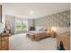 Spacious bedroom featuring wallpapered accent wall, plush carpet, and ample natural light from large windows at 206 Red Bluff St, Summerville, SC 29483