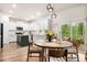 Eat-in kitchen dining area features a round table, modern lights, and access to outdoor patio at 206 Red Bluff St, Summerville, SC 29483